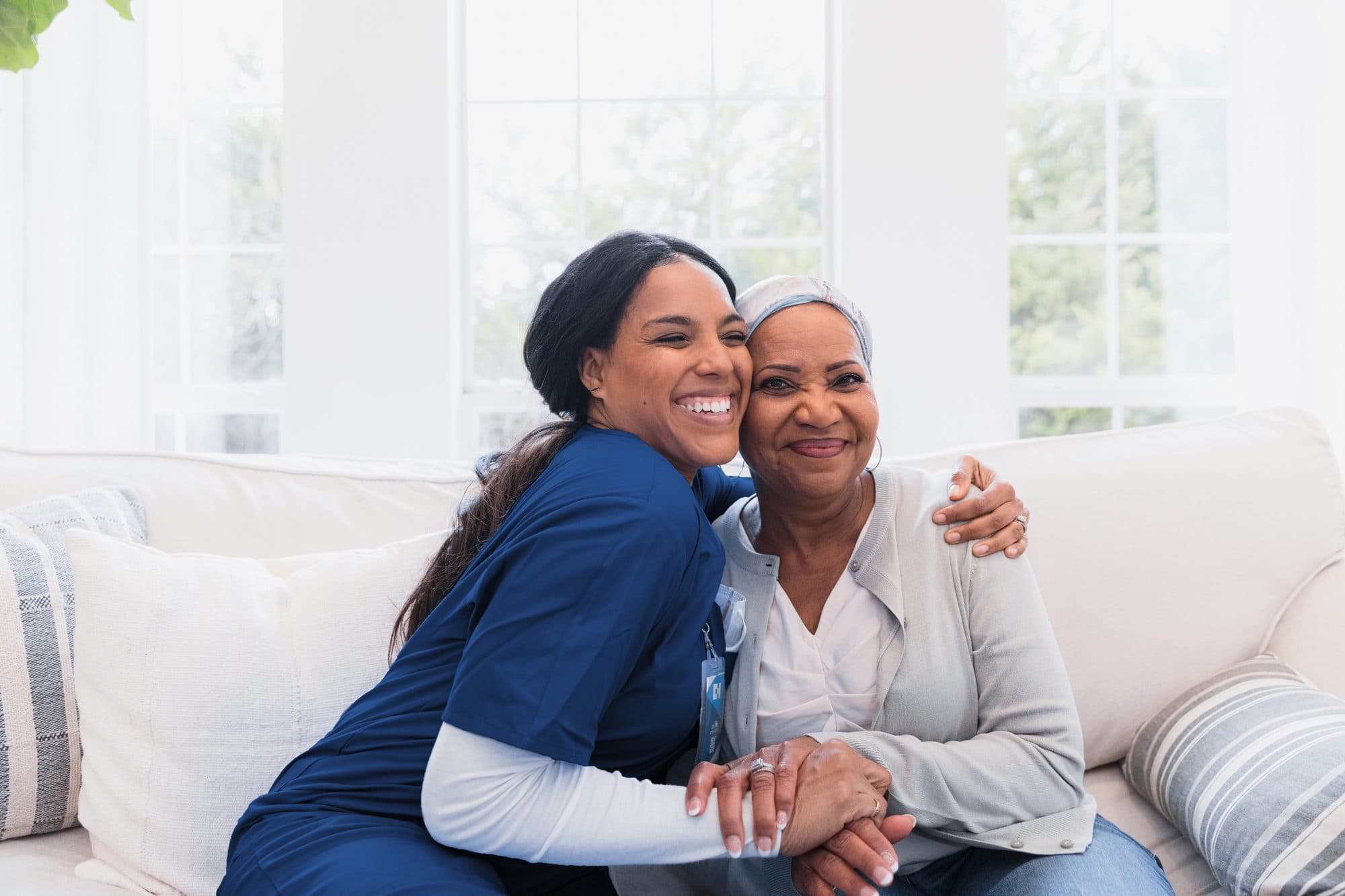 A caregiver sharing a warm moment with her client at home